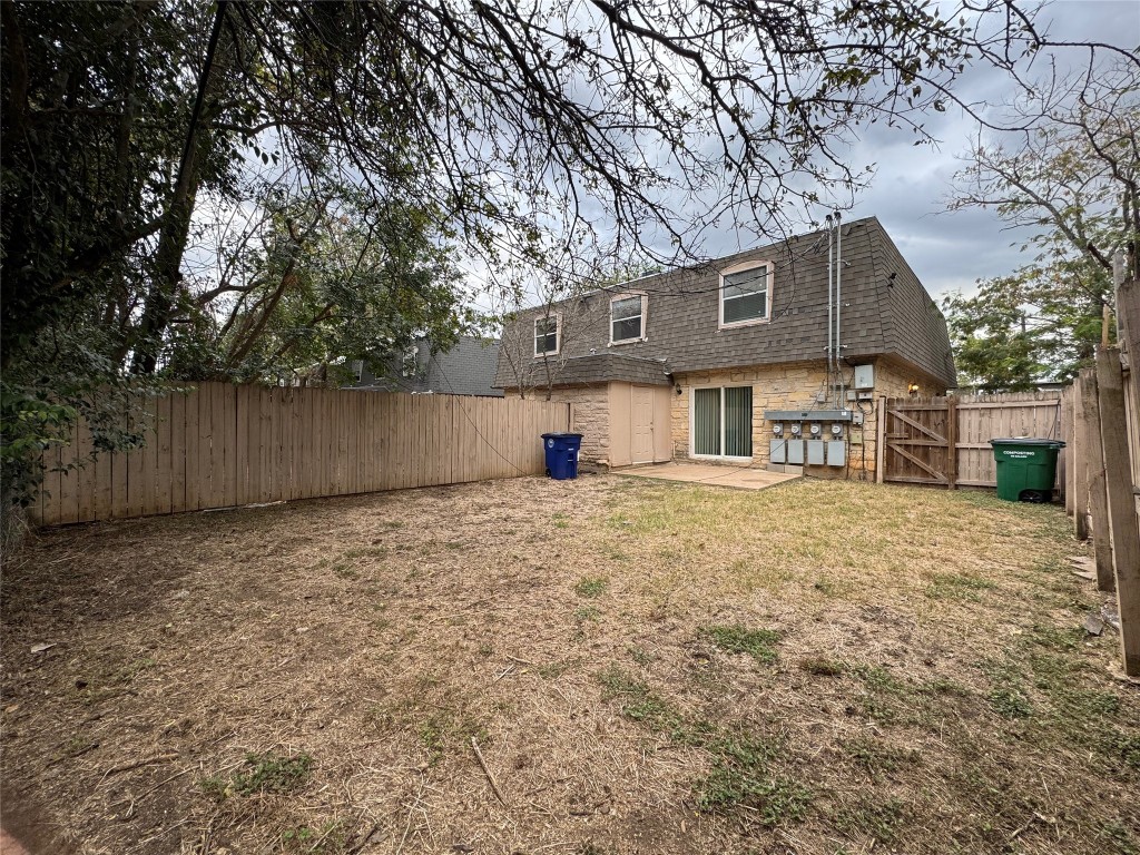 5006 West Wind Trail, Unit 104 Austin, TX 78745 - Photo 17 of 20 a front view of a house with a yard and garage