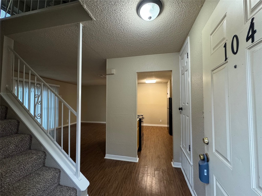 5006 West Wind Trail, Unit 104 Austin, TX 78745 - Photo 2 of 20 a view of an entryway with wooden floor