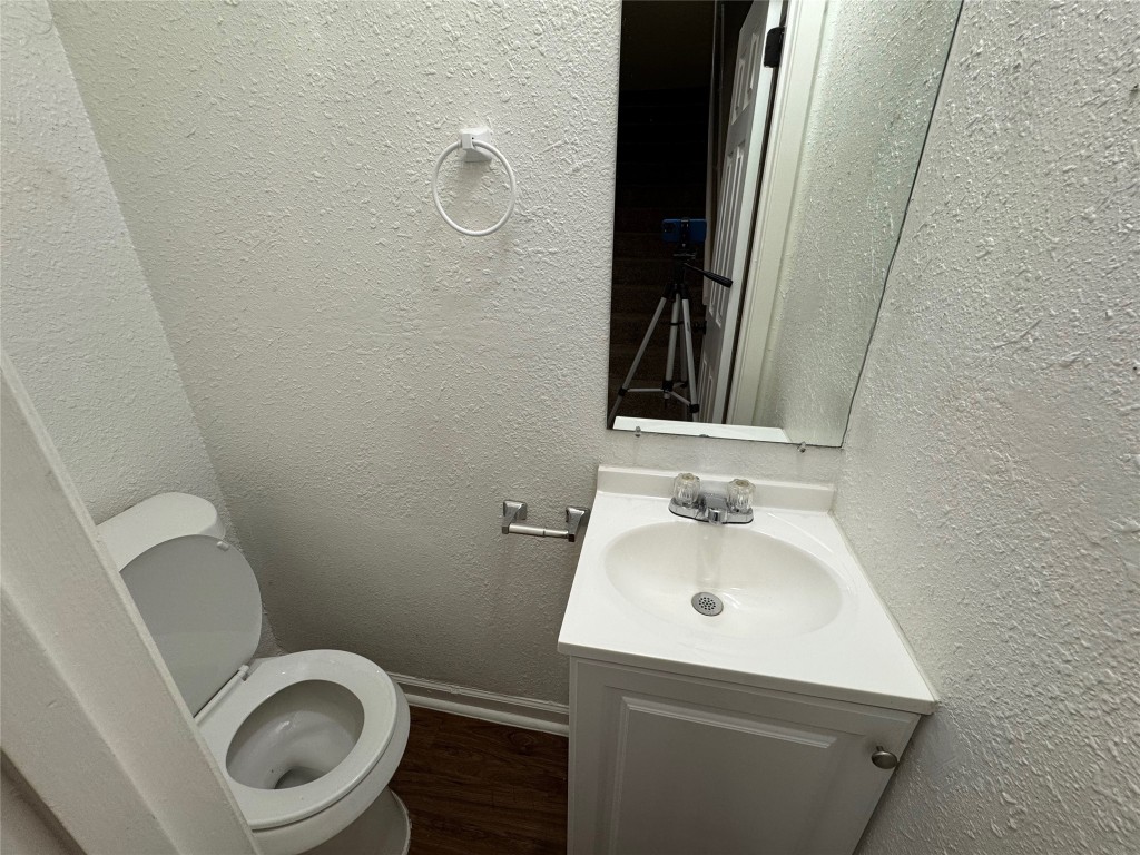 5006 West Wind Trail, Unit 104 Austin, TX 78745 - Photo 7 of 20 a bathroom with a sink mirror and toilet