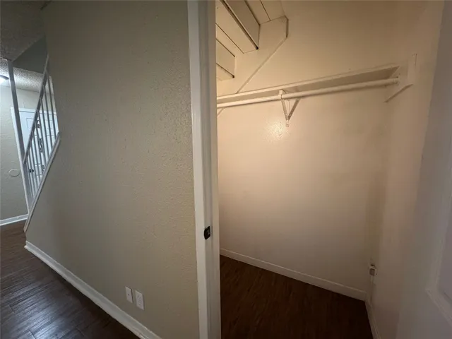 a view of a small space with wooden floor and a window