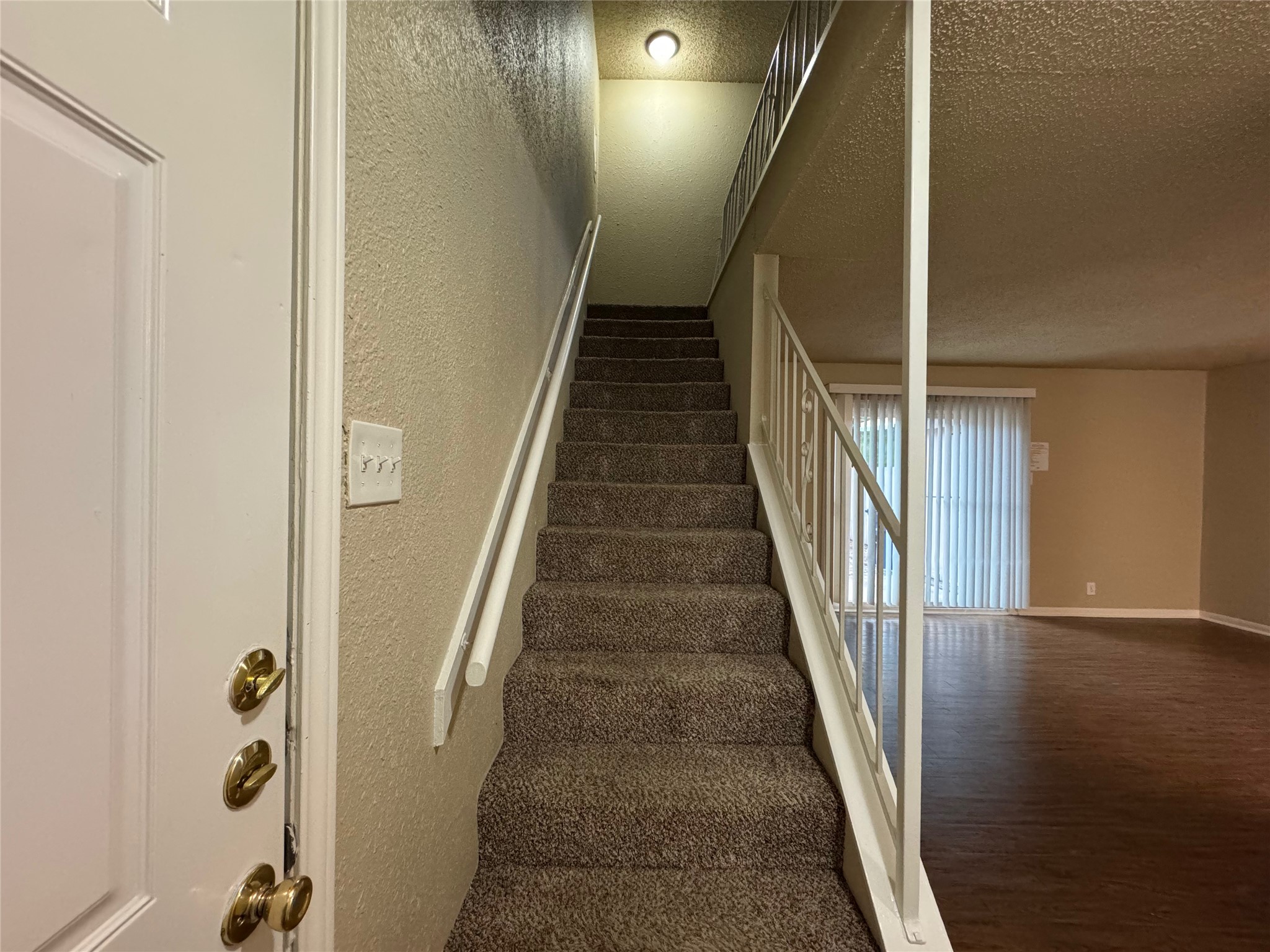 5006 West Wind Trail, Unit 104 Austin, TX 78745 - Photo 9 of 20 a view of staircase with wooden floor and stairs