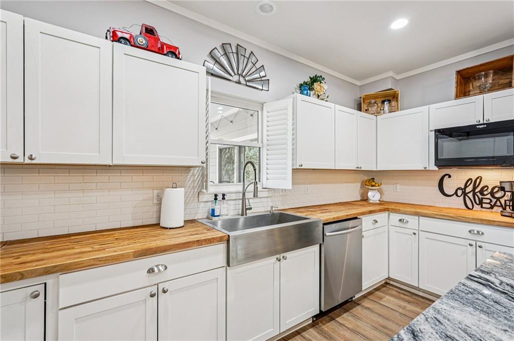744 Narroway Trail Dallas, GA 30132 - Photo 23 of 59 a kitchen with a sink dishwasher and white cabinets