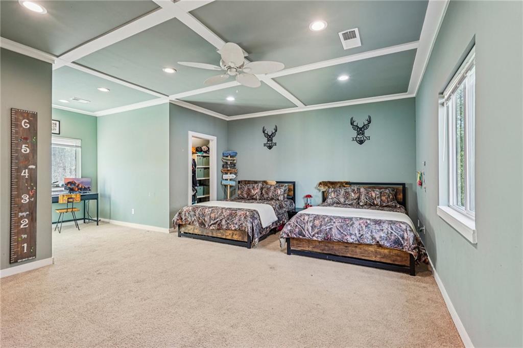 744 Narroway Trail Dallas, GA 30132 - Photo 32 of 59 a bedroom with two beds and a chandelier