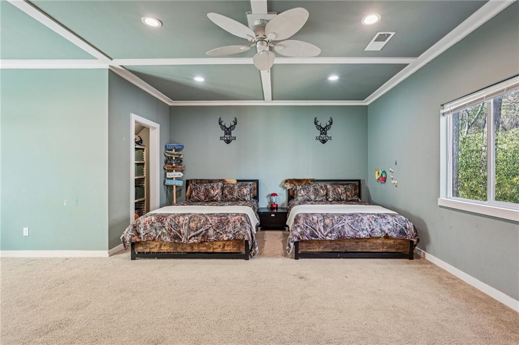 744 Narroway Trail Dallas, GA 30132 - Photo 33 of 59 a spacious bedroom with two bed and a ceiling fan