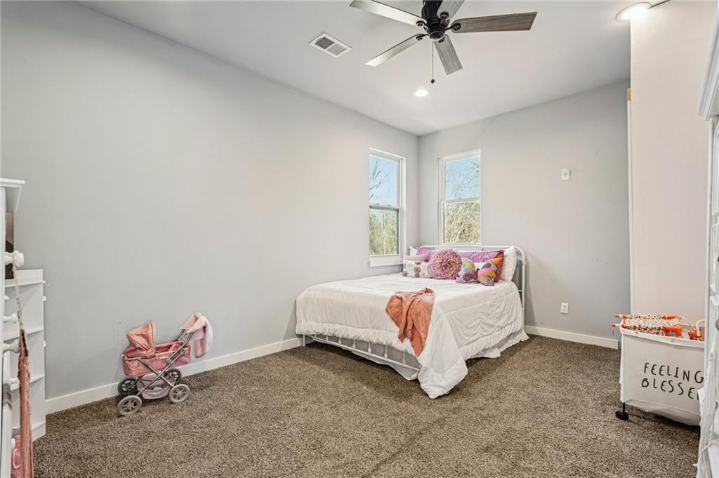 744 Narroway Trail Dallas, GA 30132 - Photo 37 of 59 a bed room with a bed and a chandelier