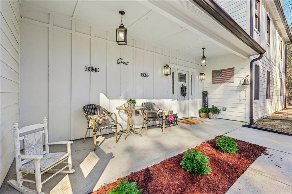 744 Narroway Trail Dallas, GA 30132 - Photo 8 of 59 a living room with patio furniture and a chandelier