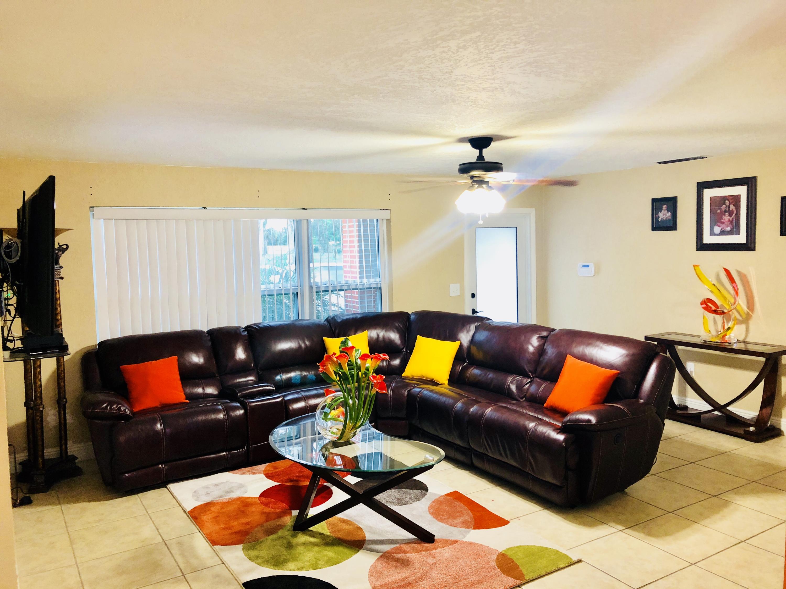 4228 Gulfstream Road Lake Worth, FL 33461 - Photo 1 of 21 a living room with furniture a rug and a chandelier