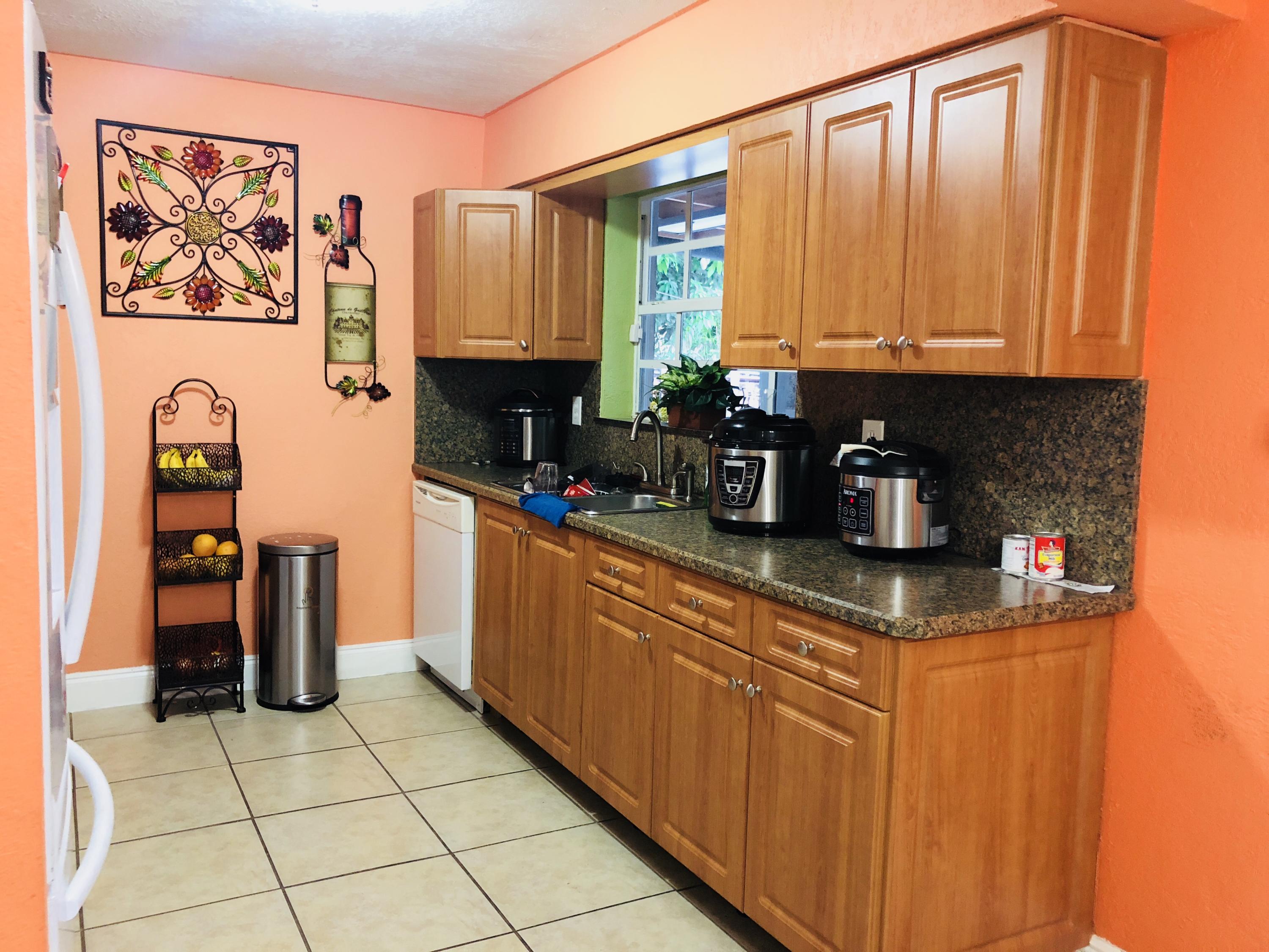 4228 Gulfstream Road Lake Worth, FL 33461 - Photo 3 of 21 a kitchen with stainless steel appliances a sink a stove and cabinets