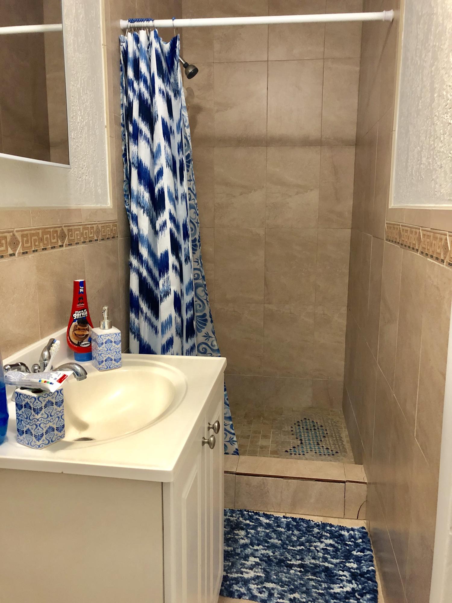 4228 Gulfstream Road Lake Worth, FL 33461 - Photo 6 of 21 a bathroom with a granite countertop shower and a sink