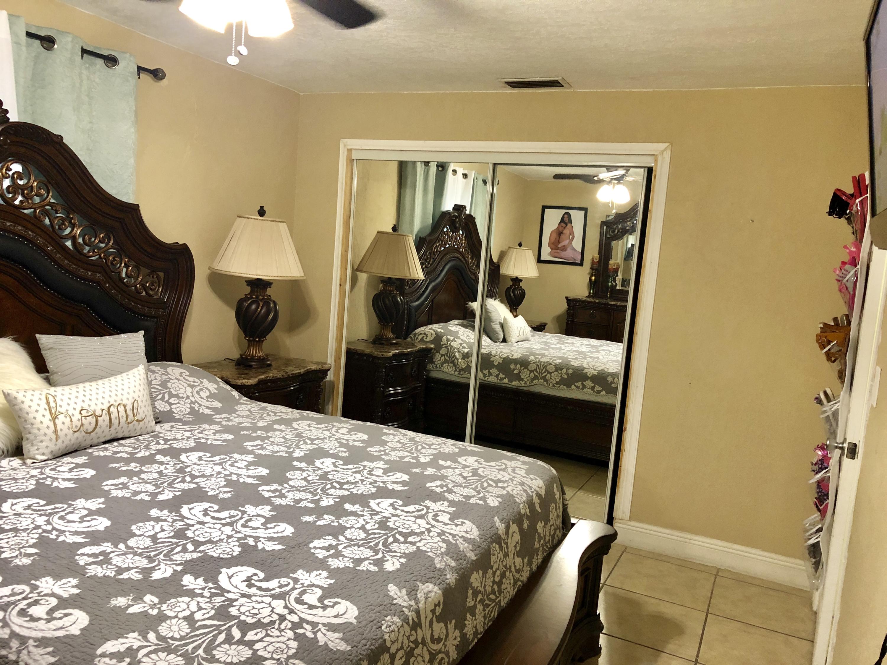 4228 Gulfstream Road Lake Worth, FL 33461 - Photo 8 of 21 a bedroom with a bed and walk in closet