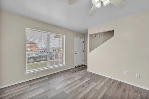 wooden floor in an empty room with a window