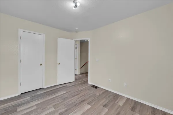 a view of an empty room and wooden floor
