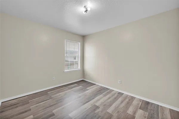 a view of room with window and hardwood floor