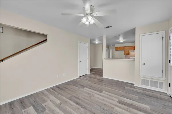 a view of an empty room with wooden floor