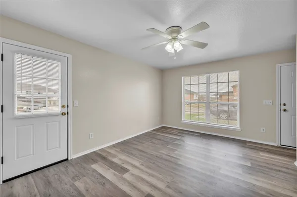 wooden floor in an empty room with a window