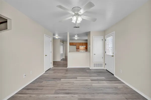 a view of an empty room with a ceiling fan