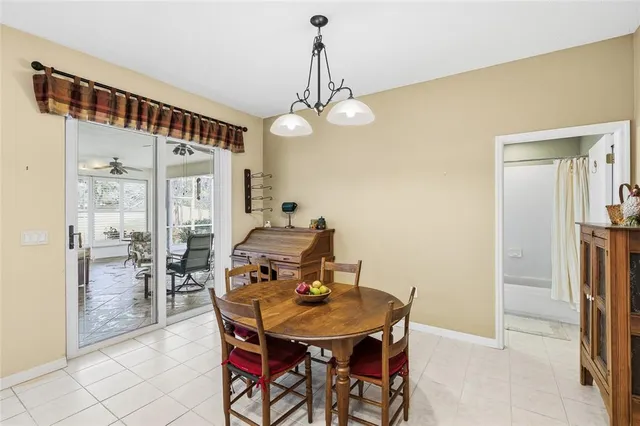 a view of a dining room with furniture and a chandelier