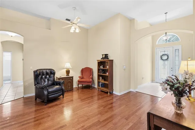 a living room with furniture and wooden floor