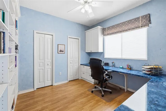 a view of a workspace with furniture and a window