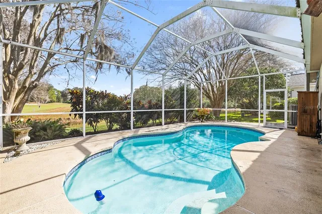 a view of a backyard with a swimming pool