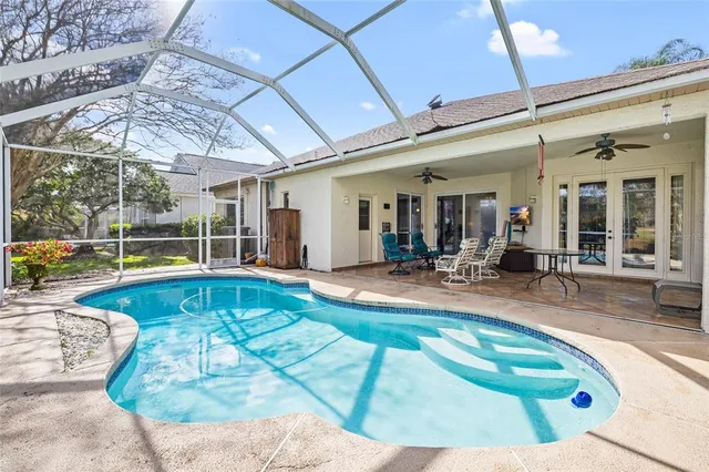 a view of swimming pool with outdoor seating