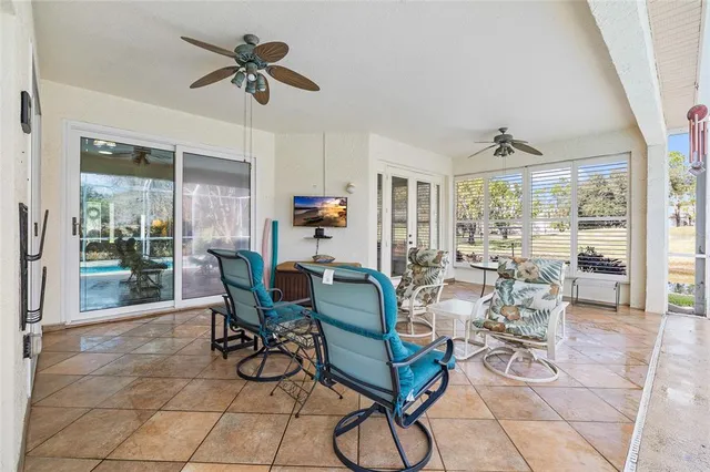 a dining room with furniture and a floor to ceiling window
