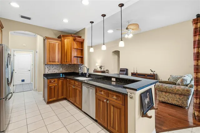 a kitchen with stainless steel appliances granite countertop a sink and a stove