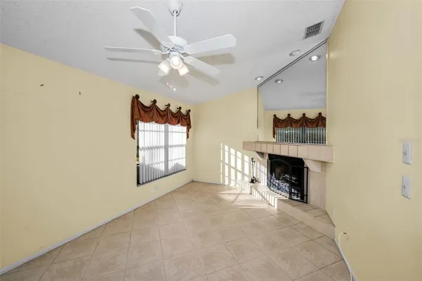 a view of a living room a chandelier and a fireplace
