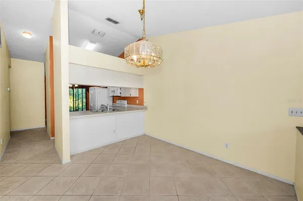 a kitchen with white cabinets sink and white appliances