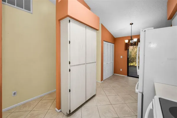 a kitchen with stainless steel appliances granite countertop white cabinets and white appliances