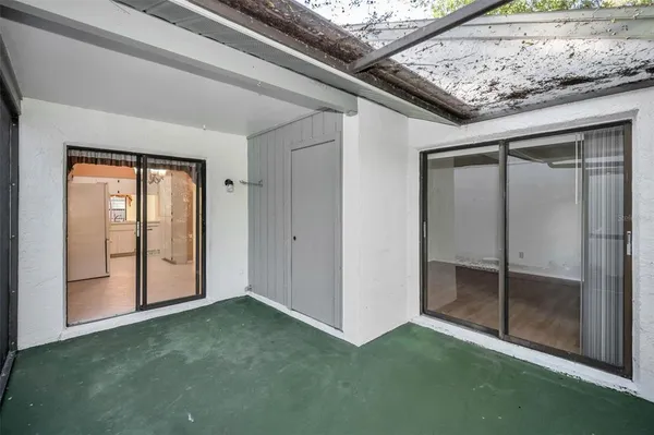 a view of a tree in front of a white house