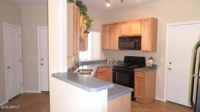 a kitchen with a stove a sink and a microwave