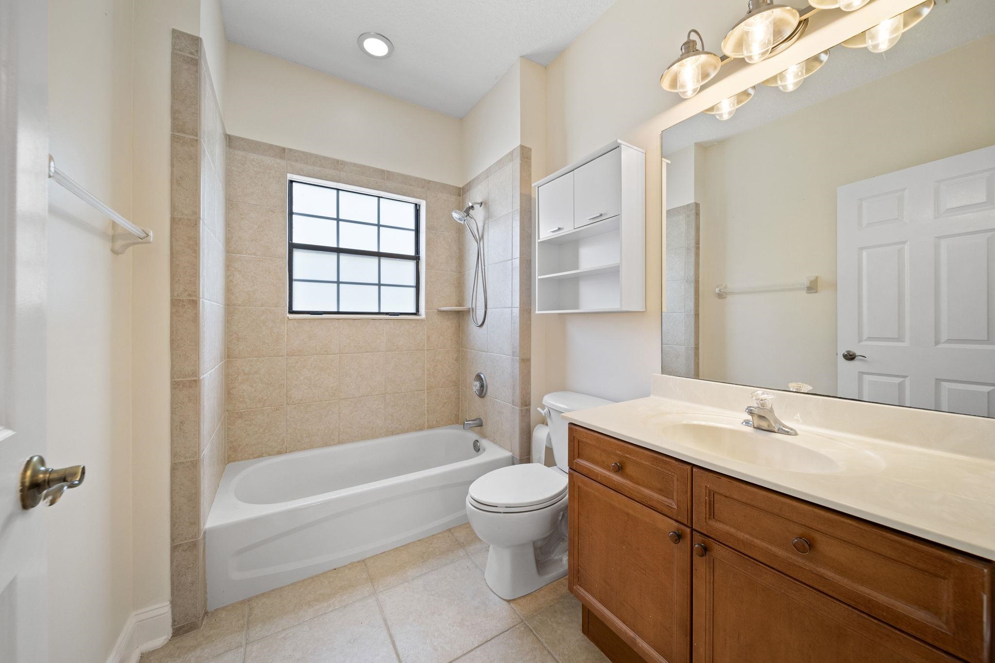 650 South Loop Street St. Augustine, FL 32095 - Photo 29 of 40 a bathroom with a sink a toilet and a large mirror