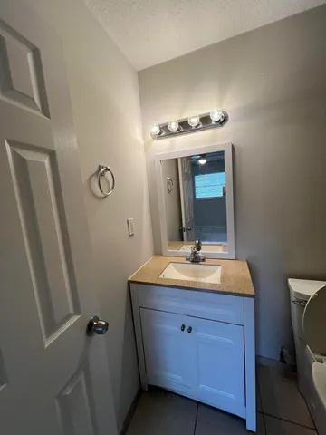 a bathroom with a double vanity sink and mirror