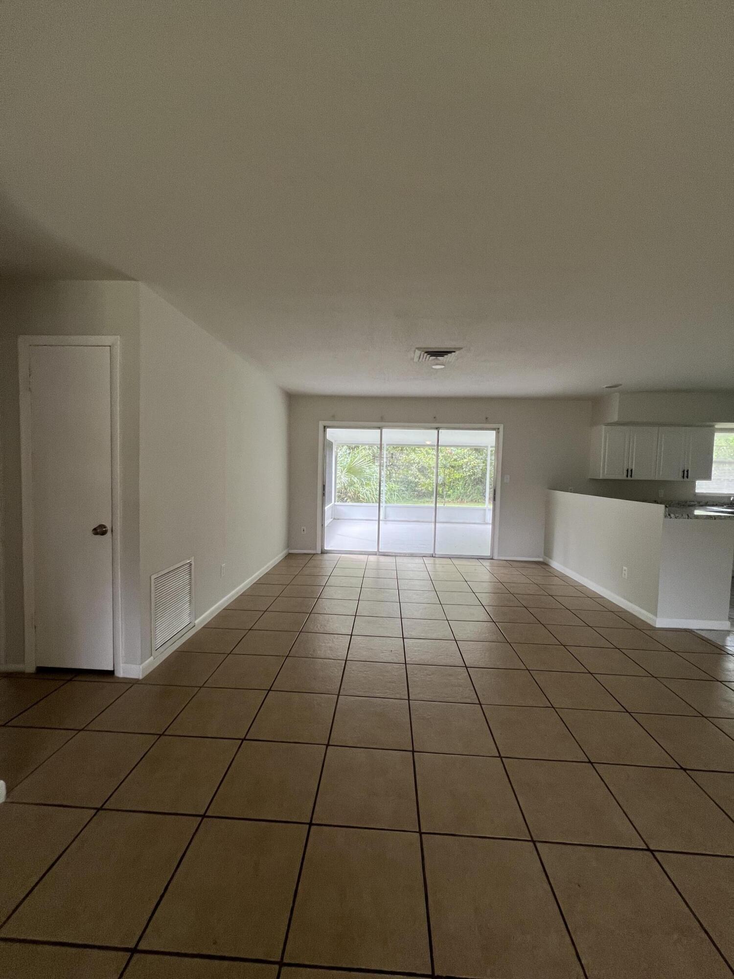 6703 Pensacola Road Fort Pierce, FL 34951 - Photo 3 of 15 a view of an empty room and window