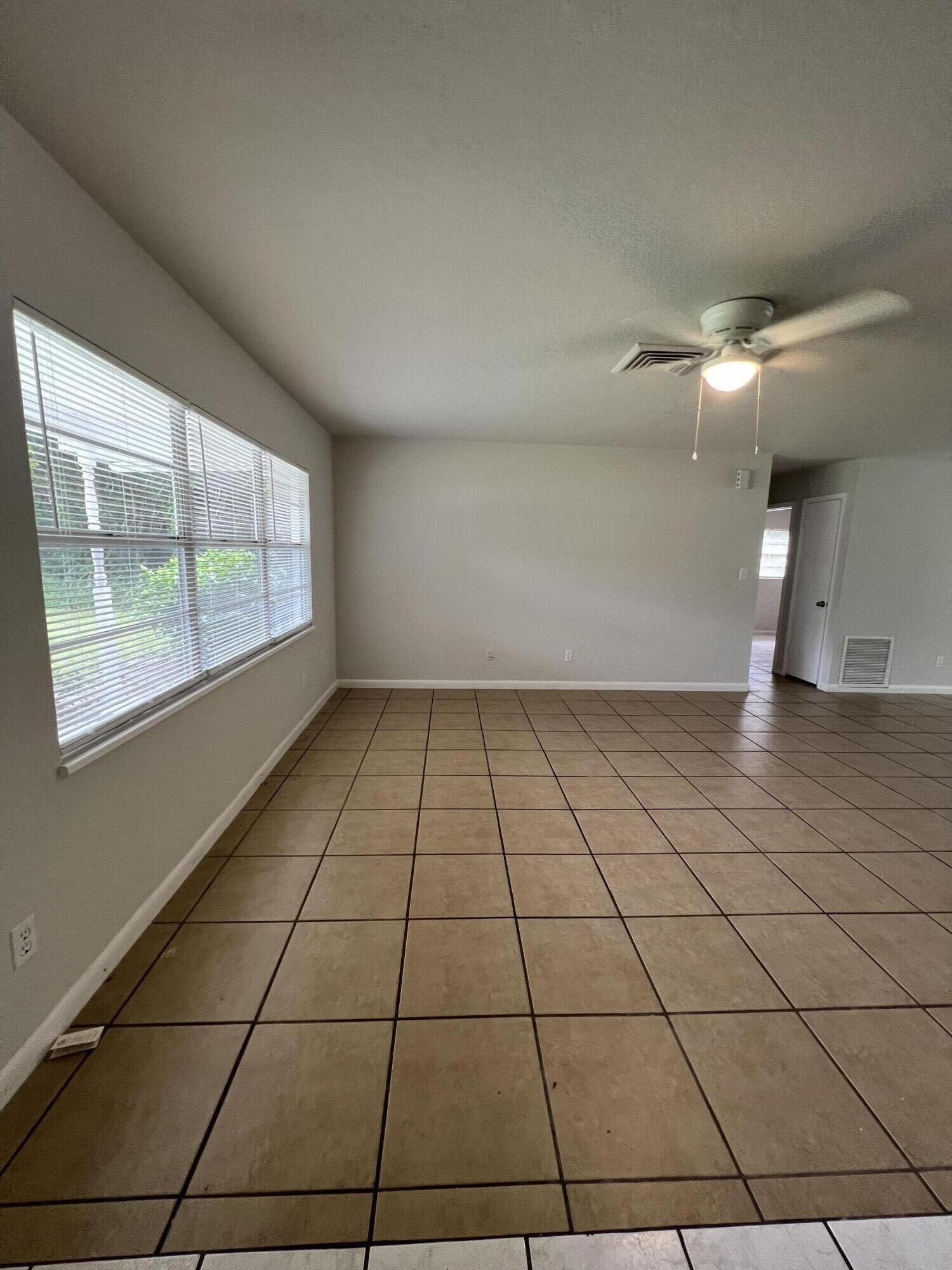 6703 Pensacola Road Fort Pierce, FL 34951 - Photo 4 of 15 a view of empty room with windows