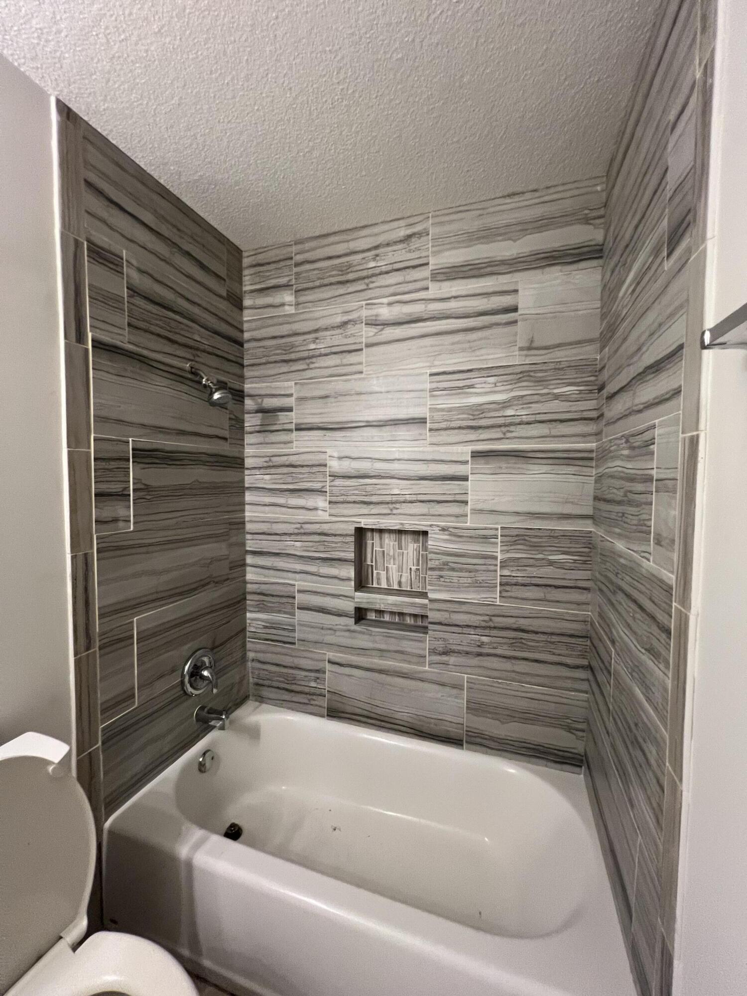 6703 Pensacola Road Fort Pierce, FL 34951 - Photo 9 of 15 a bathroom with a bathtub