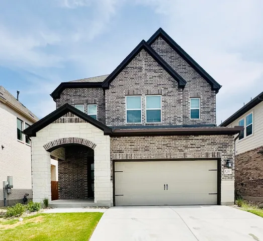 a front view of a house with garage
