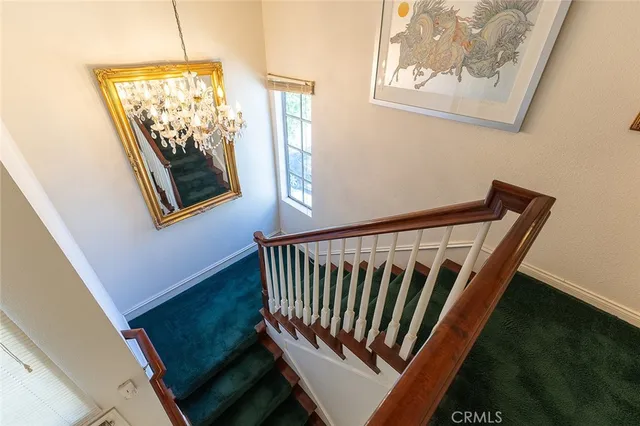 a bed sitting in a spacious bedroom next to a window