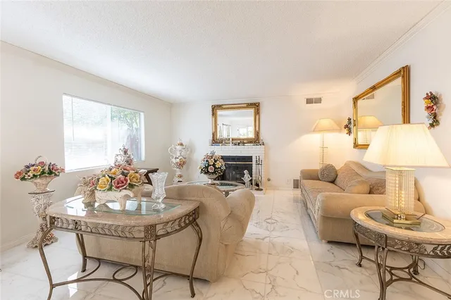 a living room with fireplace furniture and a table