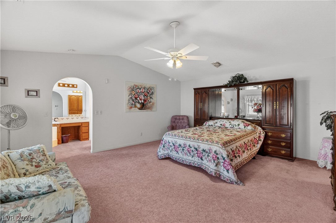 2055 Cholla Way Laughlin, NV 89029 - Photo 34 of 87 A restful primary bedroom, offering plush carpeting and a spacious attached vanity area.