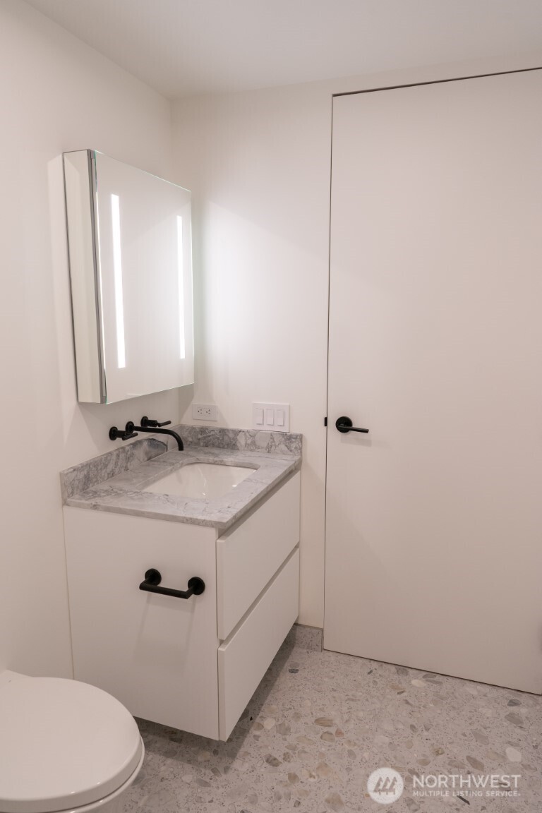 300 Virginia Street, Unit 4403 Seattle, WA 98101 - Photo 11 of 40 a bathroom with a granite countertop sink toilet and shower