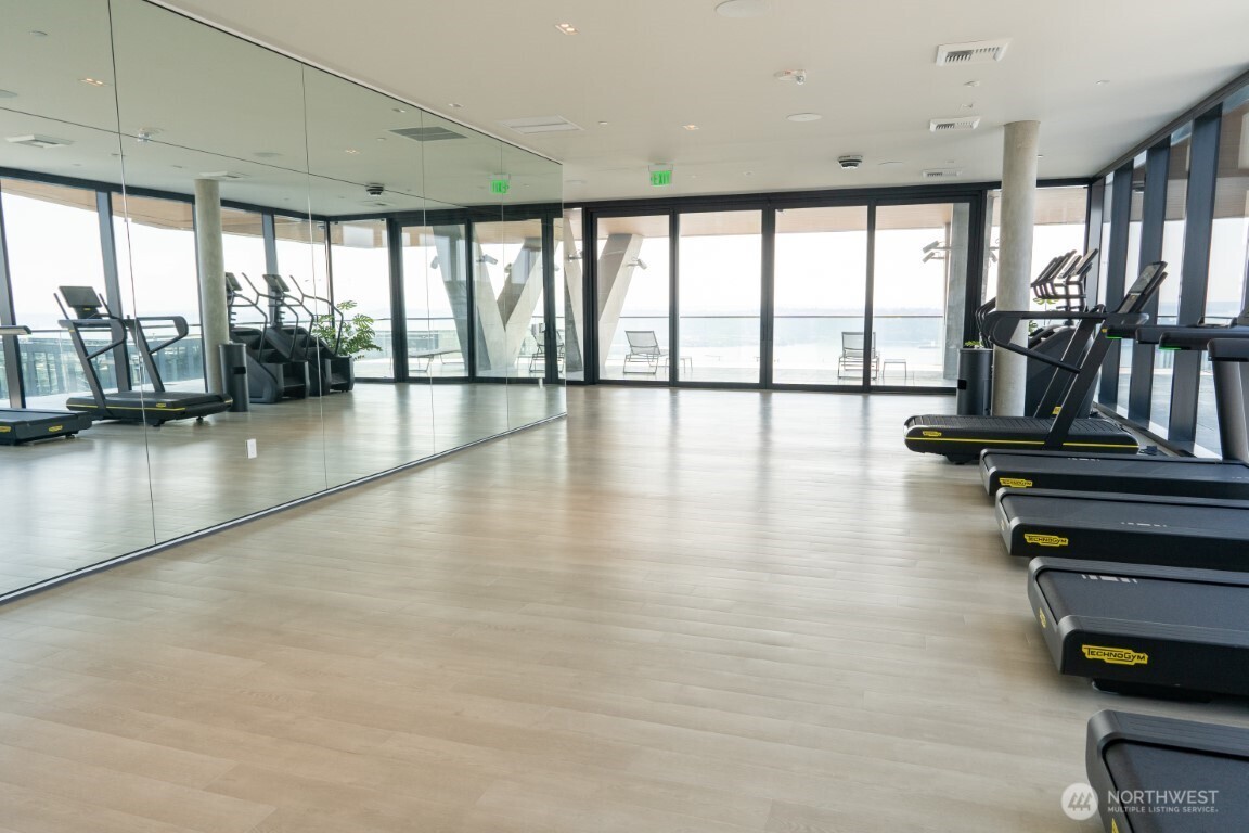 300 Virginia Street, Unit 4403 Seattle, WA 98101 - Photo 24 of 40 a view of empty room with wooden floor and floor to ceiling window