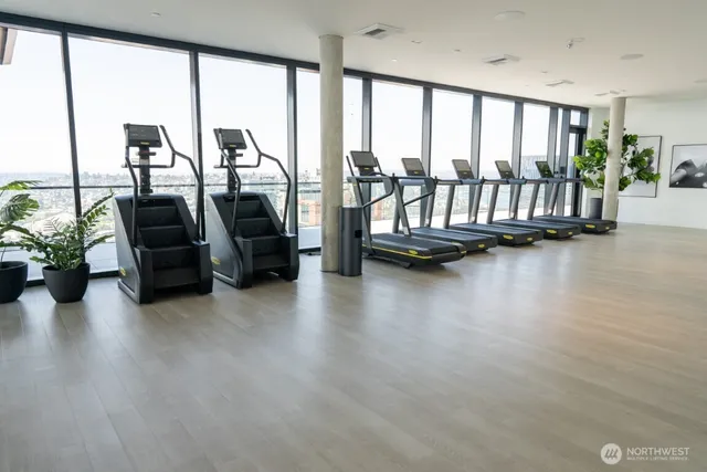 a living room with furniture and floor to ceiling window