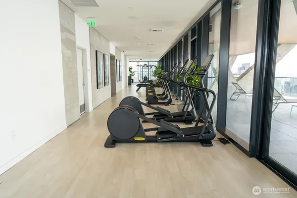 a room with gym equipment and a large window