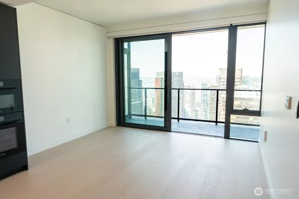 an empty room with sliding door and mountain view