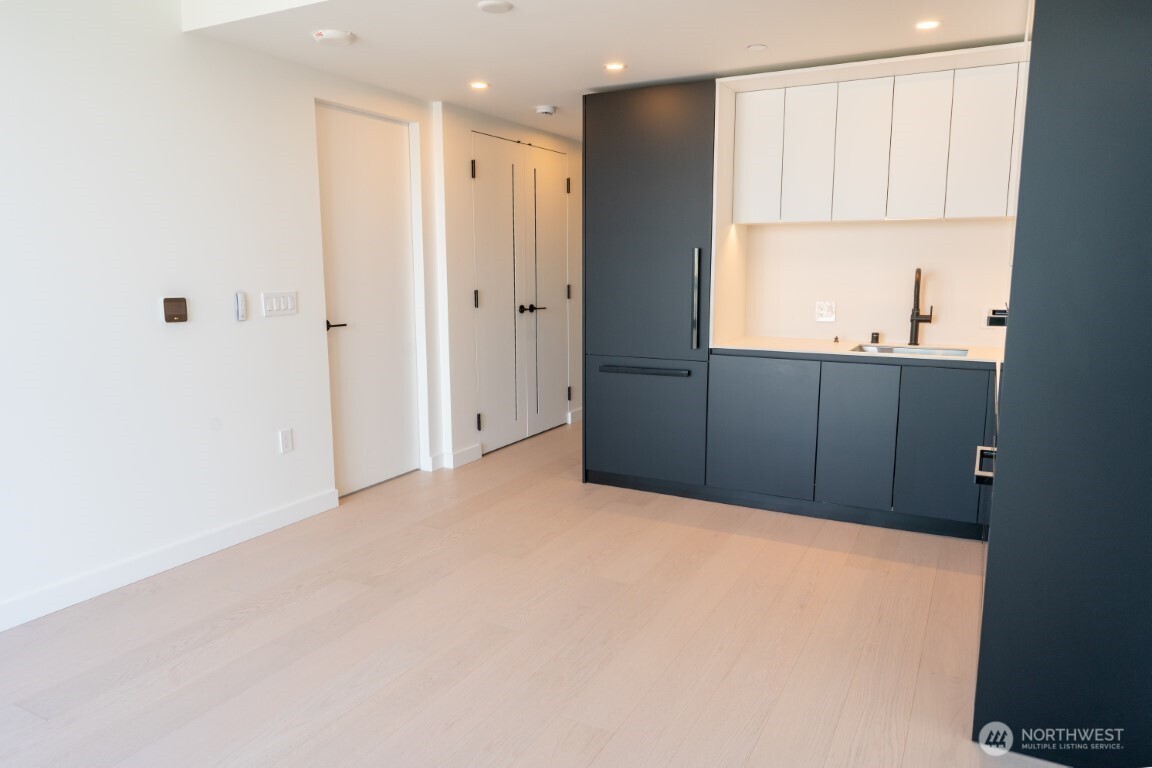 300 Virginia Street, Unit 4403 Seattle, WA 98101 - Photo 7 of 40 a view of an empty room with wooden floor