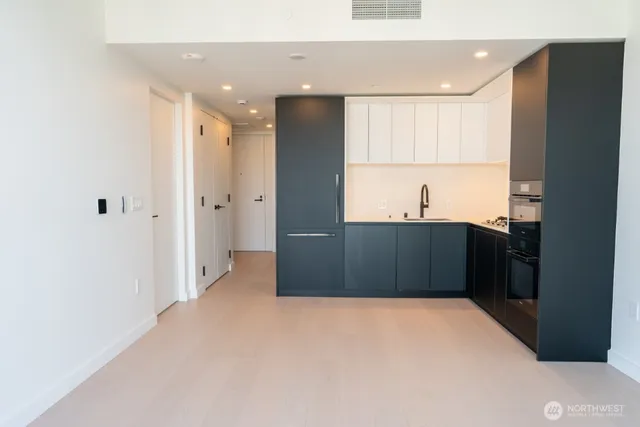 a kitchen with stainless steel appliances a refrigerator and a sink