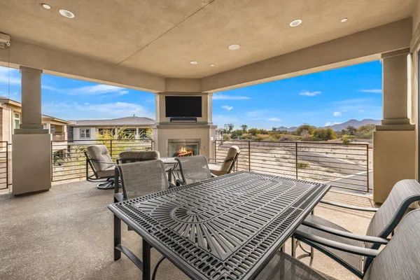 a view of a patio with a table and chairs