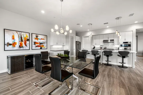 a living room with lots of furniture and kitchen view